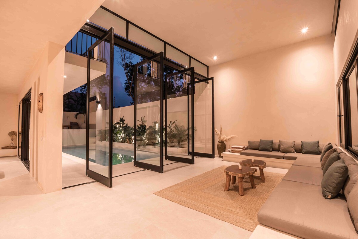 Casa H minimalist living room with large windows and pool view